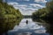 canoeist paddling down clear and calm river, with tranquil setting