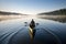 canoeist paddling peacefully in calm lake