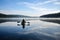 canoeist paddling peacefully on serene lake