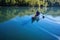 canoeist paddling through still, glassy waters