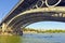 Canoeists sailing under the Triana Bridge on the Guadalquivir River in Seville Spain