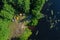 Canoes on the calm river and camp on the bank of the river. Top view. Beautiful picture of river and green banks of the river in