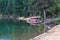 Canoes lined up on a dock along a lake