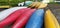 Canoes on the shore waiting for children in the summer camp