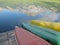 Canoes upturned on a wooden jetty and the reflection of mountains in the lake