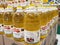 Canola oil and sunflower oil in packs for sale in commercial plastic bottles.