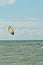 Canopy of a kiteboard and young, male kiteboarding at a tropical beach