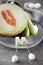 Cantaloupe melone sliced on grey plate