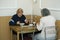 At the canteen. Old people sitting at a table and having free dinner for poor