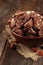 Cantuccini cookies in bowl on brown wooden background.