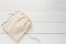 Canvas bag with drawstring, mockup of small eco sack made from natural cotton fabric cloth flat lay on white wood background