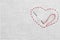 Canvas with embroidered heart and needle as background, top view. Space for text