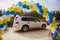 On a canvas petal tulle Cars. The bridal way decorated with balloons. twisted white, yellow, sky balloons
