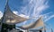 Canvas shade canopies against a blue sky.