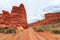 Canyon, mountain erosion, plateau, cloudy sky and mountains on the horizon. Red rocks and layers