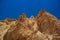 Canyon sand stone rocks textured background sharp edges of cliffs on blue sky background space