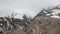 Canyon and snow-capped mountains in the mist.