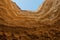 Canyon wall viewed from below in arc format with detail of water erosion marks. Namibe. Angola. Africa