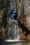 Canyoning climbing on an waterfall