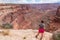 Canyonlands - Woman with scenic view from Shafer Trail Viewpoint in Canyonlands National Park near Moab, Utah, USA