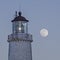 Cap-des-Rosiers lighthouse with full moon in the background.