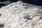 Cap of white textured foam on a sea wave near the shore during the surf