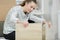 Capable young lady assembling flatpack furniture