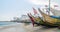 Cape Coast, Ghana - February 15, 2014: Colorful moored wooden fishing boats in African harbor town Cape Coast