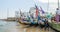 Cape Coast, Ghana - February 15, 2014: Colorful moored wooden fishing boats in African harbor town Cape Coast