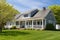 cape cod home featuring a well-manicured lawn and side gable roof