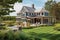 cape cod house exterior, with view of expansive lawn and gardens