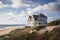 cape cod house exterior with view of rolling dunes and sparkling ocean in the background