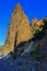 Cape Fiolent, high sharp ancient basalt rock stands on Black Sea stones coast, in the light of sunset with shadows