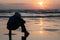 Cape Lookout sunset closeup with man silhouette sit on the beach