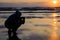 Cape Lookout sunset with man silhouette taking picture at sunset