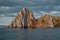 Cape Shamanka rock in Lake Baikal, background clouds, sunset light