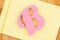 Capital pink letter B on yellow lined paper