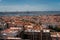 The capital of Portugal, Lisbon, top view of the orange roofs of houses, hotels and bridge