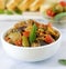 Caponata or ratatouille from a variety of vegetables served with ciabatta and olive.