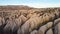 Cappadocia aerial drone or balloon view to Red and Rose valley rock formation, ancient cave churches. Goreme, Cappadocia