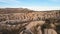 Cappadocia aerial drone or balloon view to Red and Rose valley rock formation, ancient cave churches. Goreme, Cappadocia