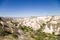 Cappadocia, Turkey. Picturesque Valley of Pigeons with carved into the rock houses - caves. In the background Uchisar