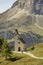 Cappella di San Maurizio, a lonely church at Magical Dolomite peaks of Pizes da Cir, Passo Gardena at blue sky and sunny day,