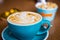 Cappuccino in Big Blue Cups in Modern Vegan Cafe