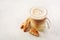 Cappuccino with biscotti or cantucci on a white table