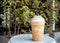 Cappuccino blended in plastic cup. Served with whipped cream. Refreshment drink. Favorite caffeine beverage