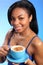 Cappuccino in a blue cup for beautiful young girl