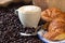 Cappuccino, brioches and newspaper with background