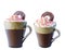 Cappuccino coffee in a glass mug with whipped cream, decorated with red, purple, green pastry balls. A circle of chocolate in crea