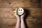 Cappuccino coffee with smiley face on wooden table